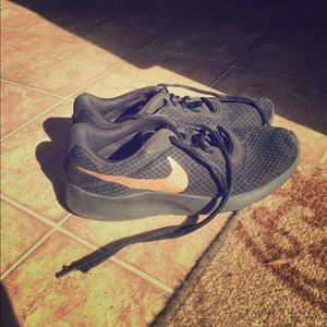 Black and gold Nike sneakers